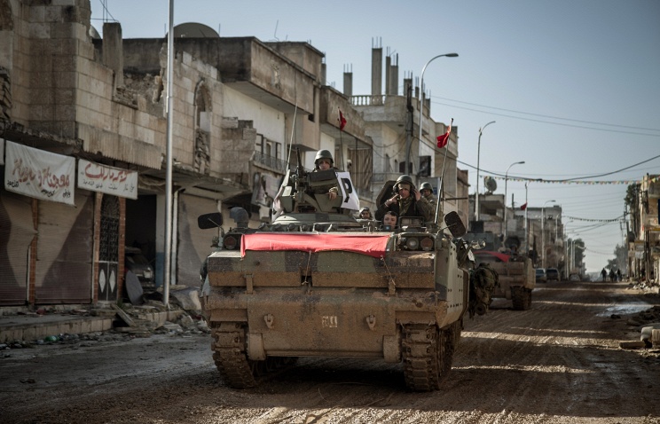 Turkish army's armored vehicles and tanks drive in Syrian town of Kobani, Feb 22, 2015